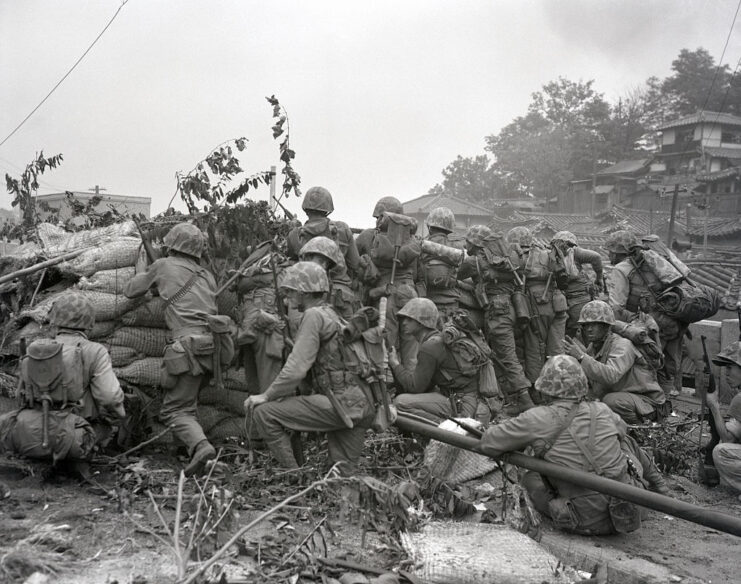 US Marines taking cover behind a low-lying wall
