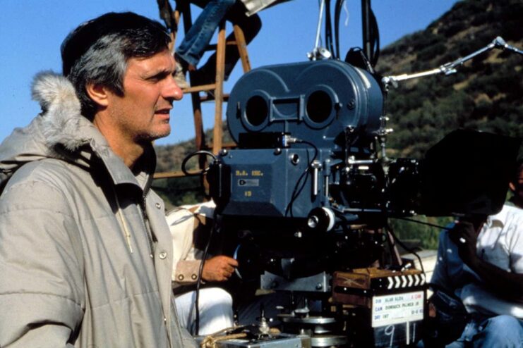 Alan Alda standing on the set of 'M*A*S*H'