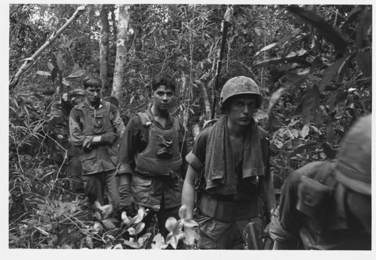 US soldiers walking through the Vietnam jungle
