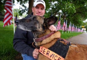 Man standing behind a service dog