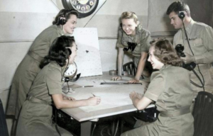 Four members of the Women's Air Raid Defense (WARD) and a male co-worker gathered around a table