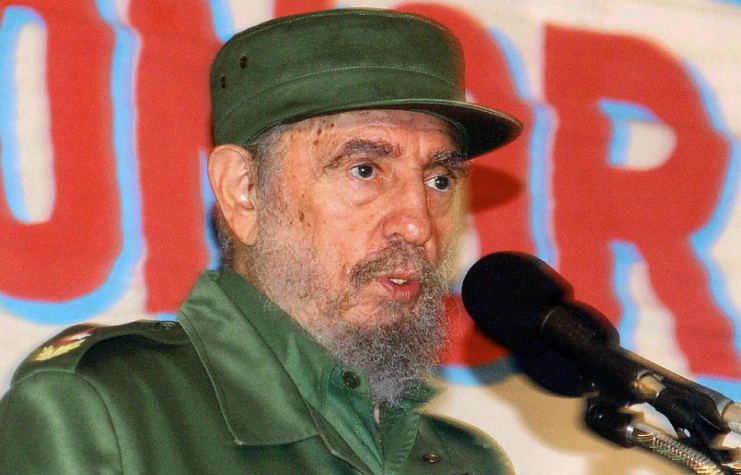 Fidel Castro speaking at a podium