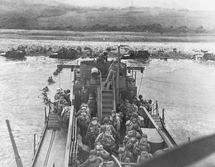 Troops standing on a landing craft off the coast of Omaha Beach