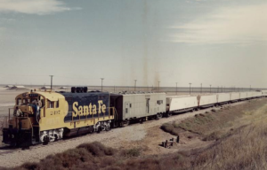 White train traveling down a railroad