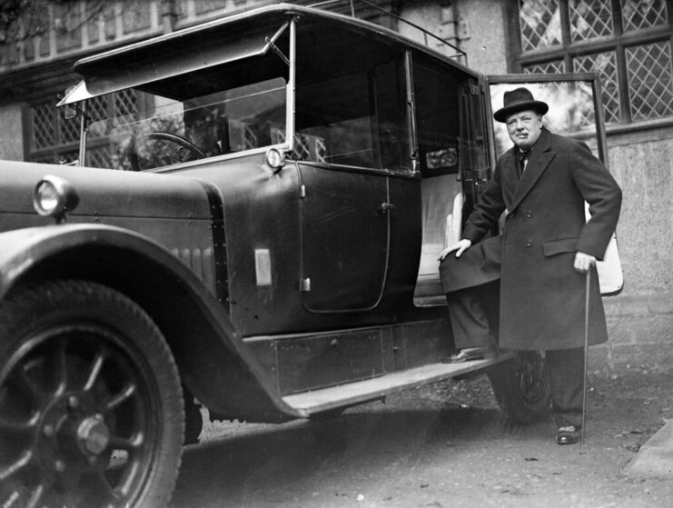 Winston Churchill standing next to a vehicle