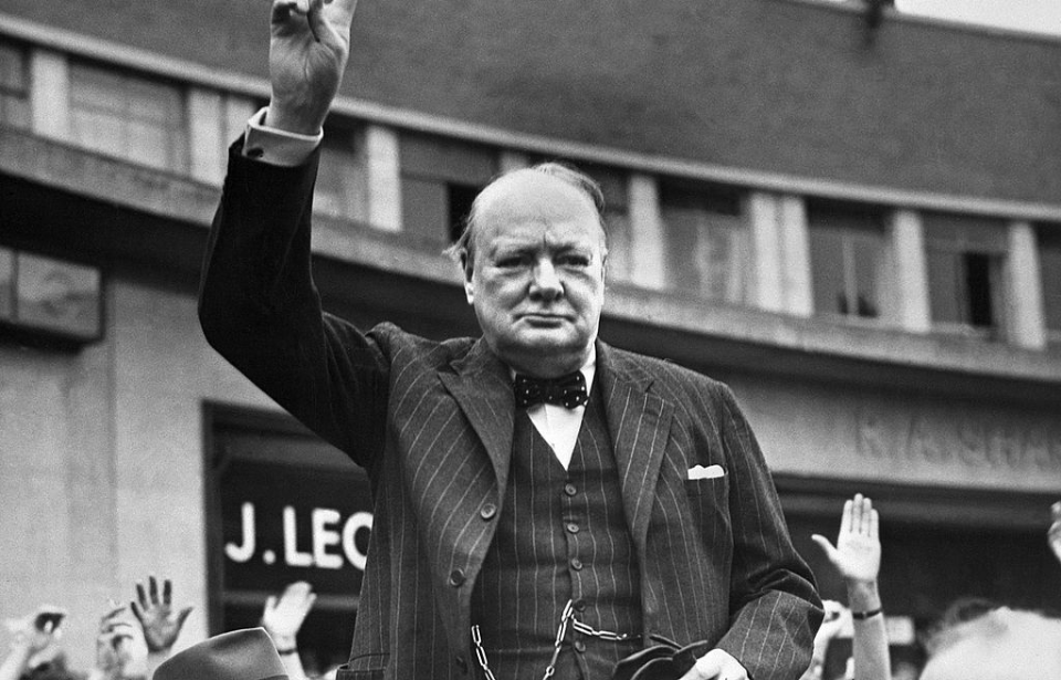 Winston Churchill standing in the middle of a crowd