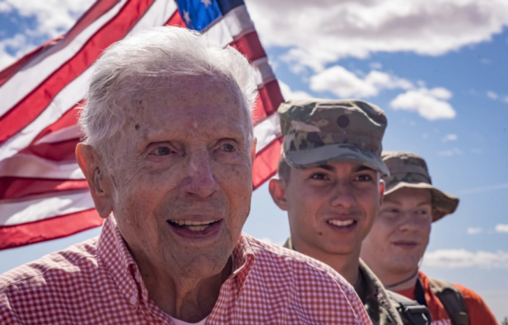 Colonel Ben Skardon standing with two younger servicemen