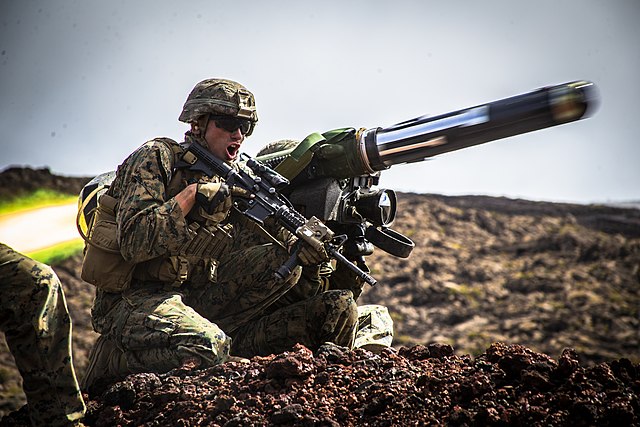 US Marine Corps Sgt. Troy Mole firing an FGM-148 Javelin while kneeling outside