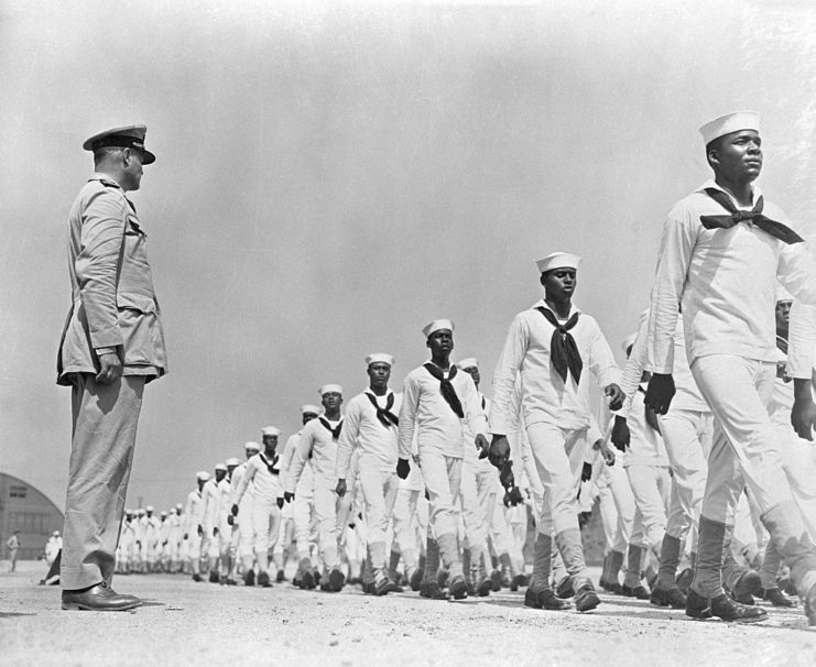 African American sailors walking before a superior