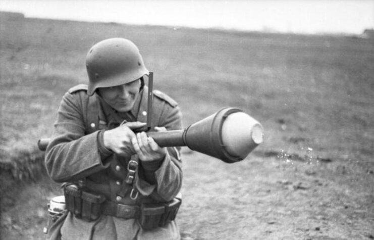 Soldier aiming a Panzerfaust in the middle of a grassy field