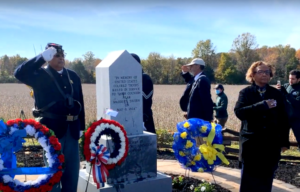 Members of the U.S. Colored Troops standing at attention around an American Civil War memorial