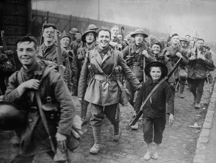 French boy walking with British soldiers