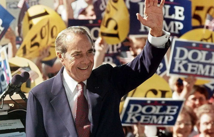 Bob Dole waving at a crowd of supporters