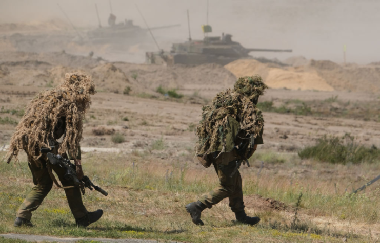 Two Norwegian snipers running across a field