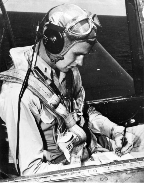 George H.W. Bush sitting in the cockpit of his aircraft