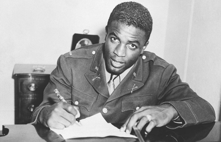 Jackie Robinson writing at a desk