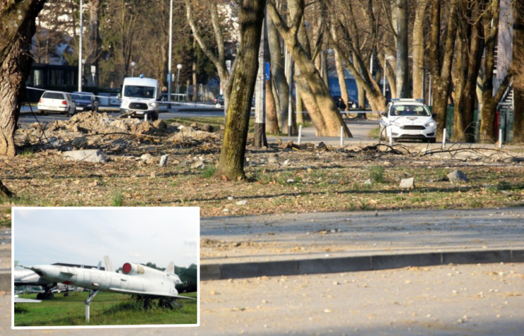 Police tape surrounding a crater in the earth + Tupolev Tu-141 on display