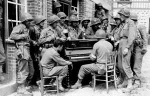 American soldiers standing around a Victory Vertical piano
