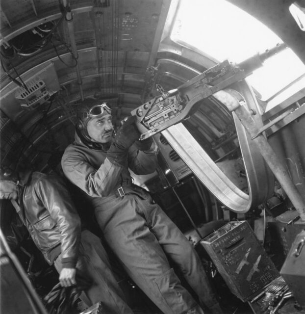 Clark Gable aiming his gun aboard an aircraft