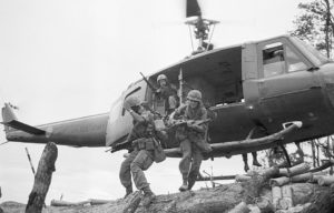 Soldiers jumping off a helicopter