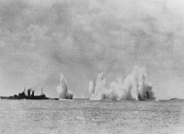 HMS Exeter (68) under attack at sea