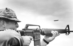 US Navy sailor firing an M16 rifle