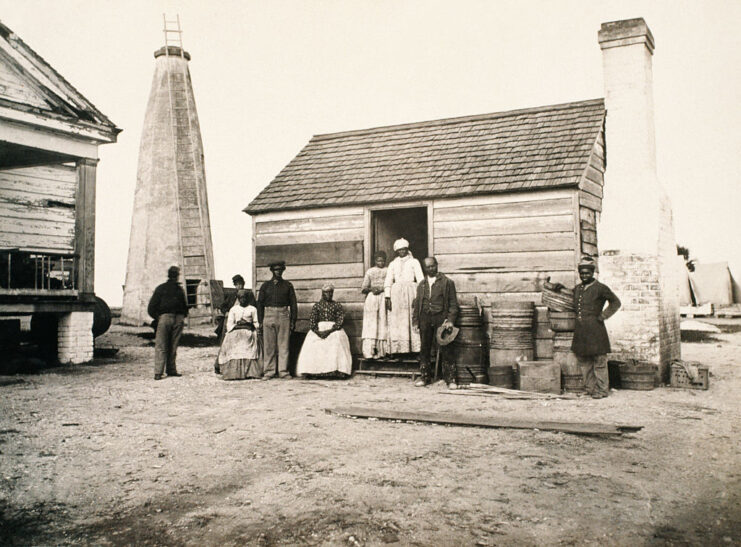 Slaves standing outside a building on a plantation