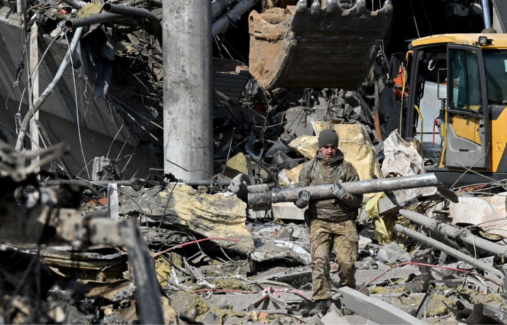 Ukrainian soldier holding a rocket fragment