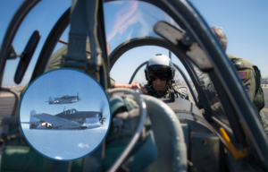 Dean Laird sitting in the rear seat of a Beechcraft T-34 Turbo-Mentor + Two aircraft in flight