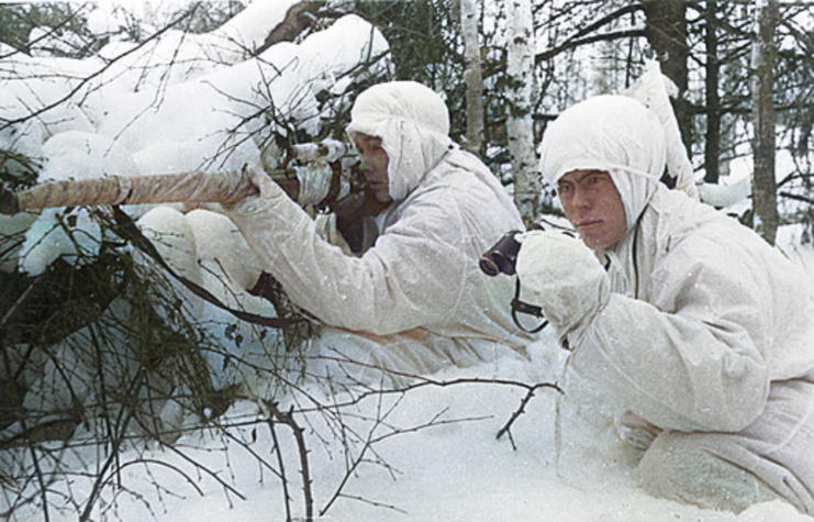 Finnish soldiers crouched in the snow