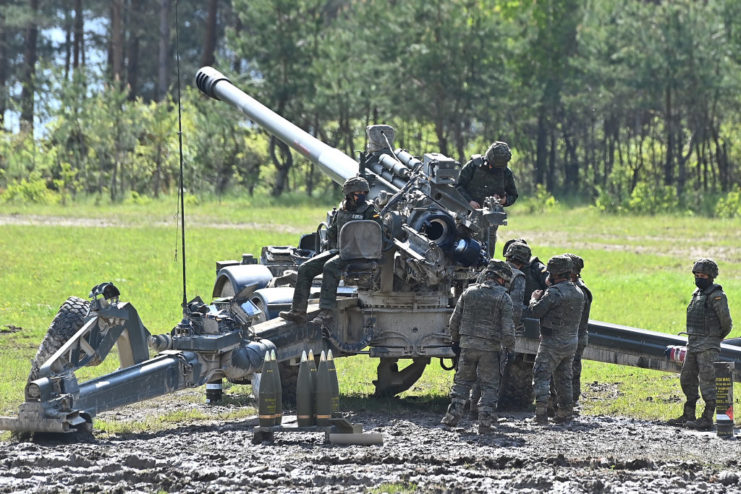 Spanish soldiers operating an M777 howitzer