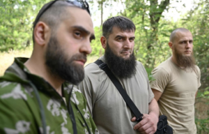 Three Sheikh Mansur Battalion volunteers standing together