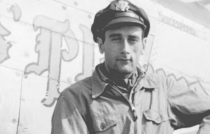 Bruce Carr standing in front of his North American P-51D Mustang "Angels' Playmate"