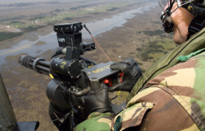 Door gunner manning an M134 Minigun from a Chinook helicopter