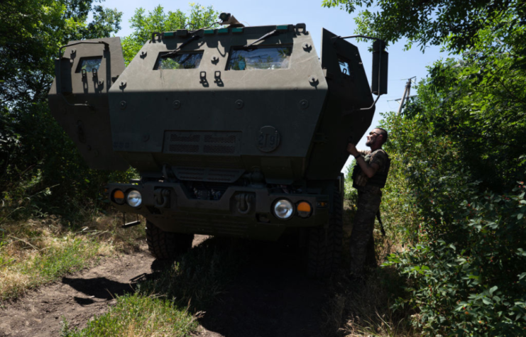 Ukrainian serviceman opening the door of an M142 HIMARS