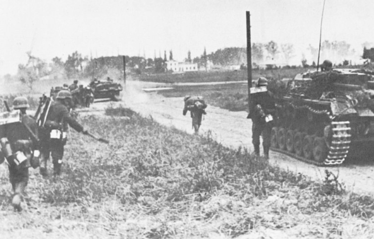 German soldiers running down a dirt road