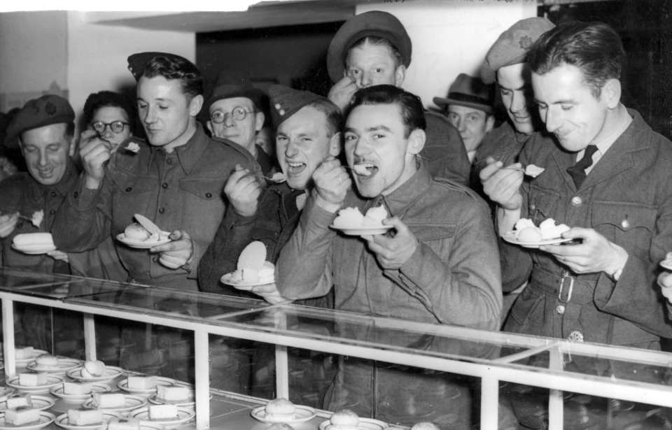 British troops eating ice cream at a shop counter