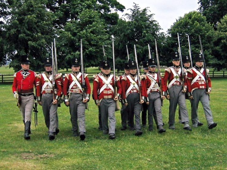 Line of re-enactors dressed up as British soldiers during the American Revolution