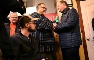 Jared Polis shaking Rich Fierro's hand