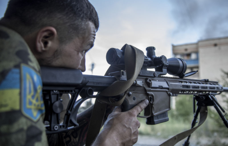 Ukrainian sniper aiming his rifle