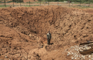 Soldier with Charlie Troop, 1st Squadron, 102nd Cavalry Regiment, New Jersey Army National Guard standing in the middle of a large crater