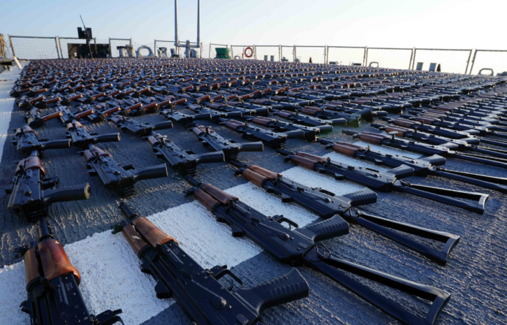 Rows of AK-47s laid out on the deck of a US Navy ship in the Gulf of Oman