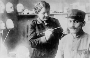 Anna Coleman Ladd standing beside a seated French soldier