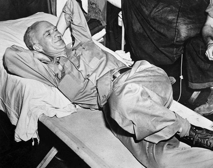 Ernie Pyle lying on a cot