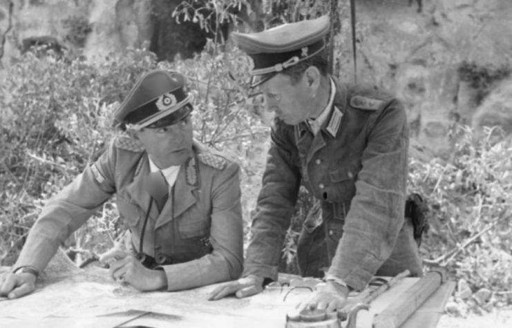 Ernst-Günther Baade and another German officer looking over documents at a table