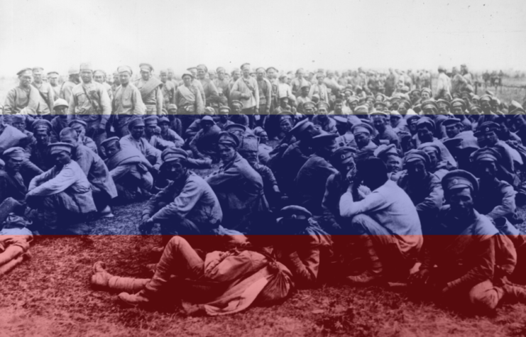 Russian prisoners of war (POWs) standing together + Russian flag