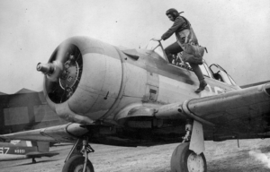 Pilot climbing into the cockpit of an aircraft