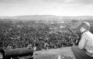 American soldier keeping watch over prisoners of war (POWs) held at the Rheinwiesenlager