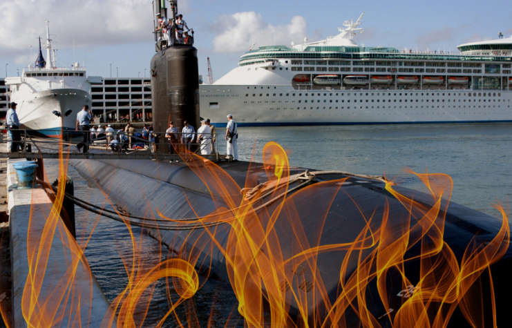 Sailors standing atop the USS Miami (SSN-755) while at port + Flames