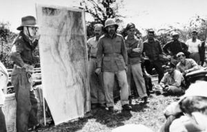 Orde Wingate standing with his men and a large map